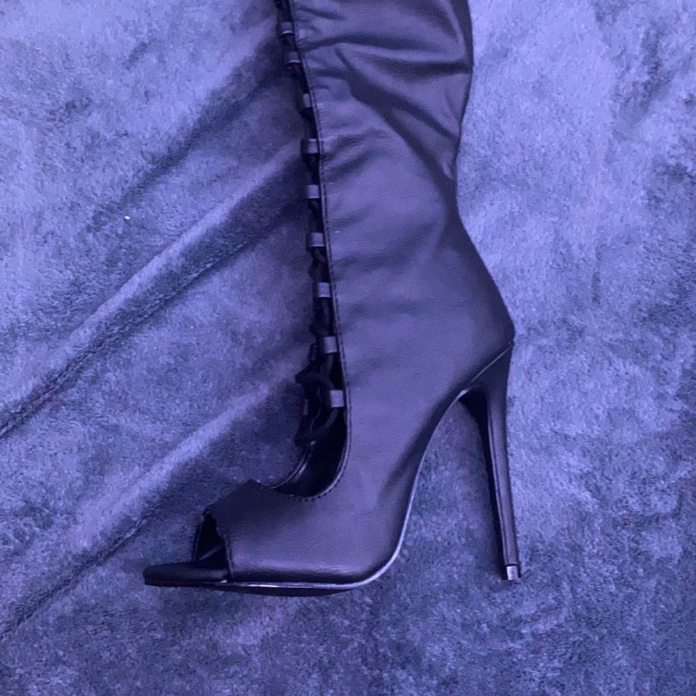 Black over the knee gladiator style boot.